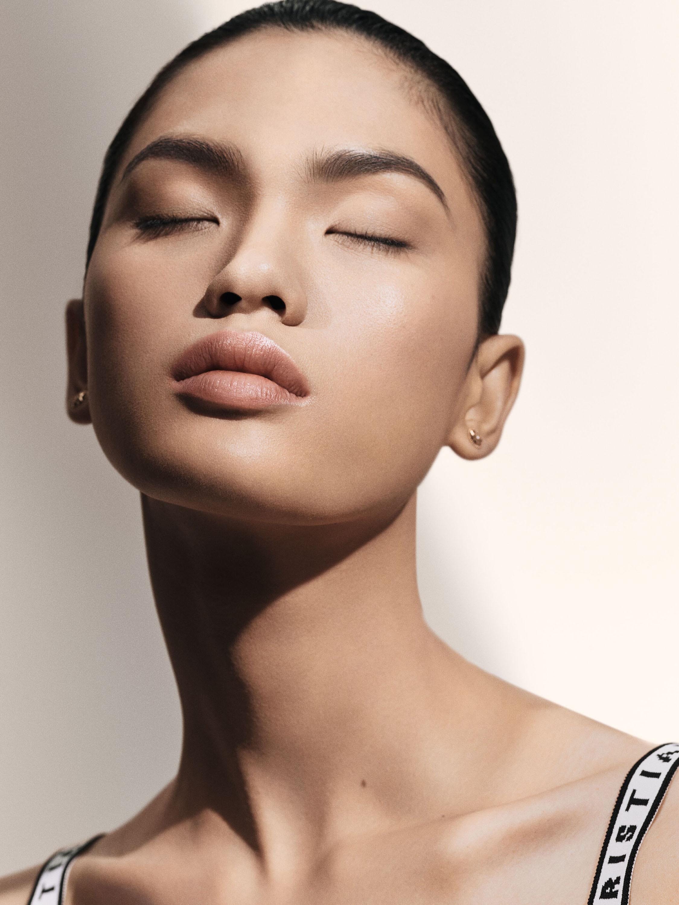 Front view of a woman’s face with her eyes closed 